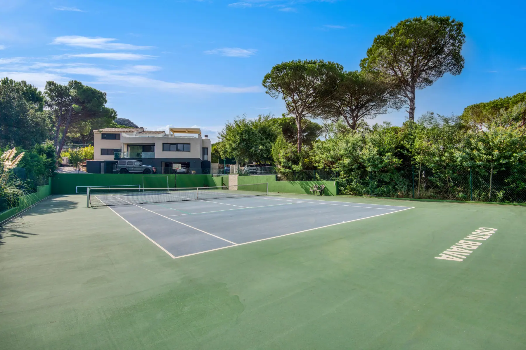 The estate from the air — private tennis court inside the grounds
