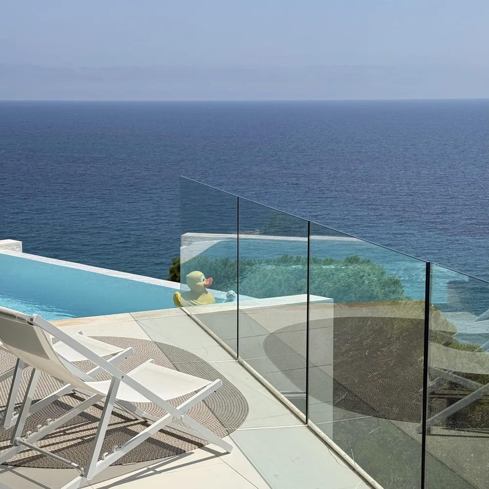 Loungers by the infinity pool above the cove
