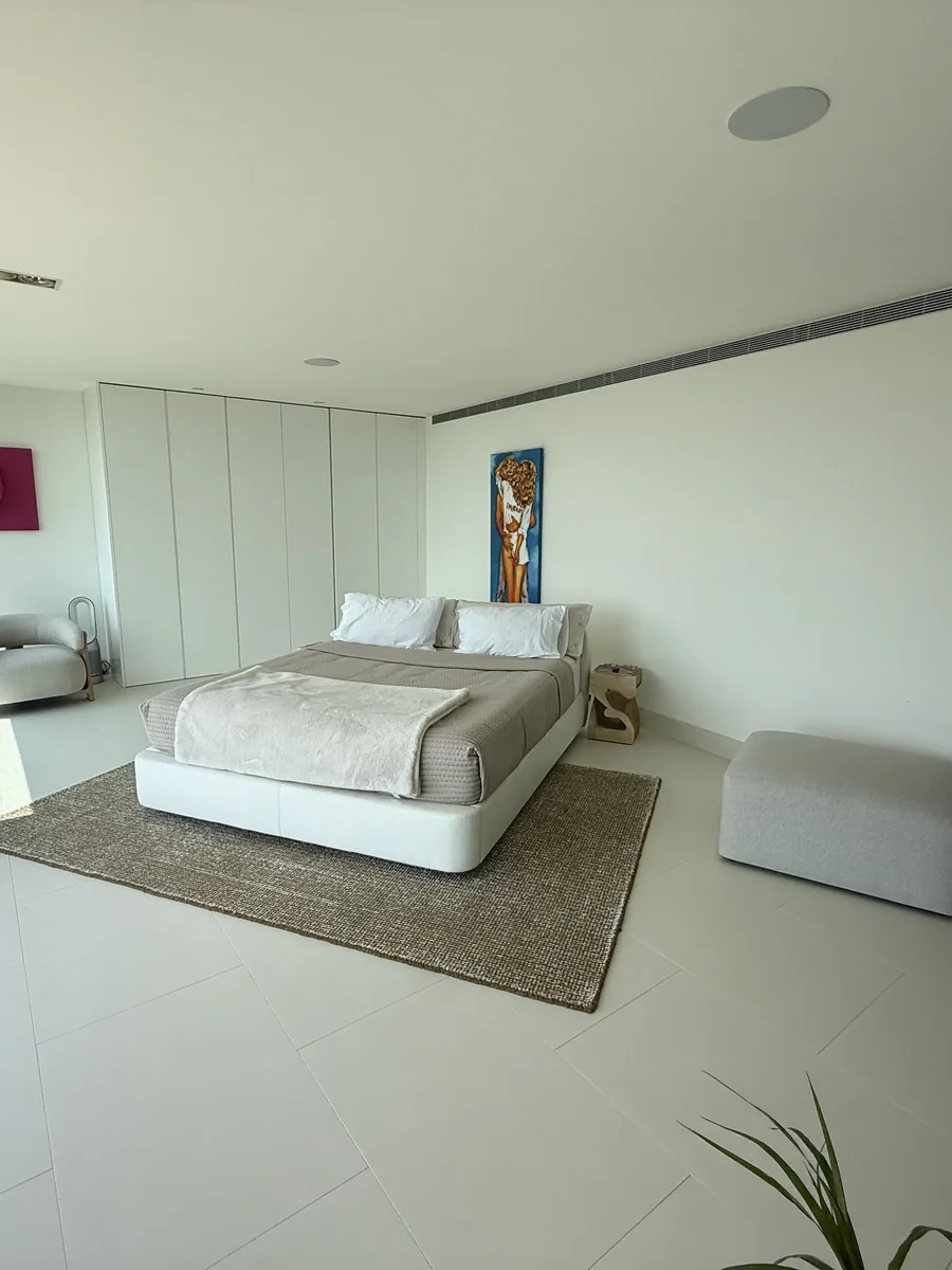 Bedroom with full-height glazing onto the sea