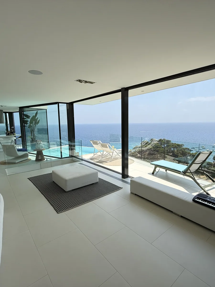 Living room open to the terrace and the sea