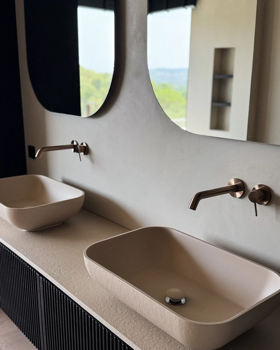 Twin basins on a fluted vanity with bronze wall taps