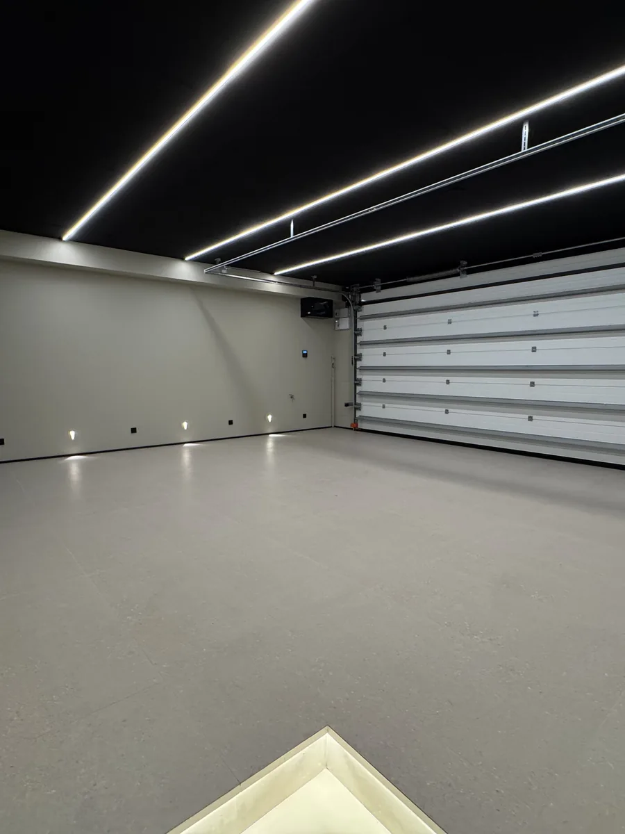 The garage, lit and finished, with room for three cars