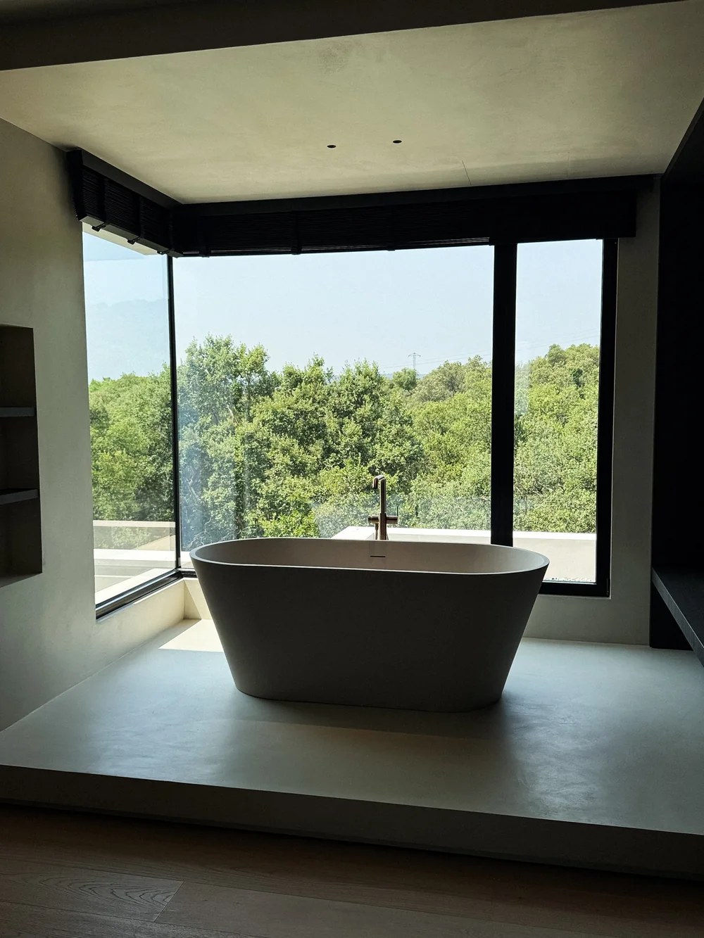 A freestanding bath set into a picture window