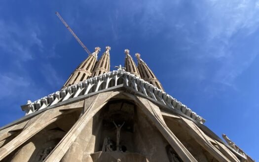 Passion façade of the Sagrada Família in Barcelona against a blue sky